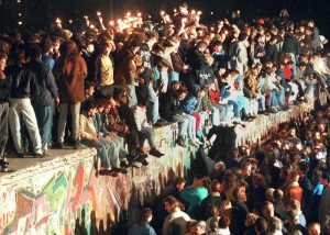 epa04469615 (FILE) A file photo dated 11 November 1989 shows people celebrating the opening of the border between East and West Germany on the Berlin Wall in Berlin, Germany. After the border was opened, millions of East Germans streamed across the border into West Berlin. The 25th anniversary of the fall of the Berlin Wall will be celebrated in Berlin on 09 November 2014.  EPA/STR