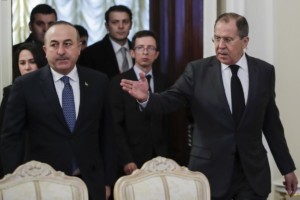 Russian Foreign Minister Sergey Lavrov, right, welcomes Turkey's Foreign Minister Mevlut Cavusoglu, left, for the talks in Moscow, Russia, Tuesday, Dec. 20, 2016. Foreign ministers of Russia, Turkey and Iran are meeting on Tuesday to discuss Syria, but the talks are likely to be overshadowed by the assassination of Russia's ambassador to Turkey the previous night by an Ankara policeman, who after killing his victim cried out: "Don't forget Aleppo! Don't forget Syria!" (AP Photo/Pavel Golovkin)